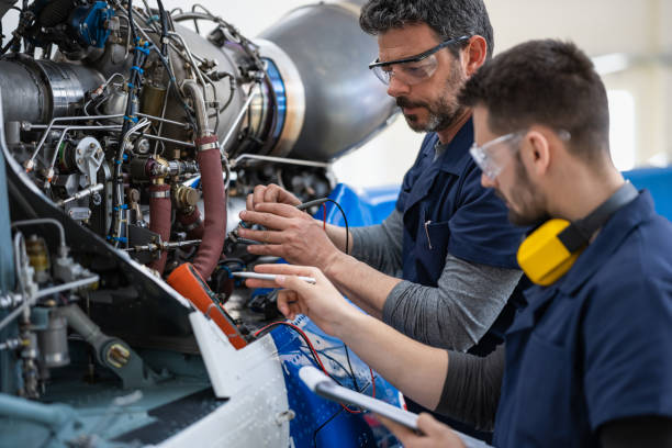 Technicians servicing an aircraft engine