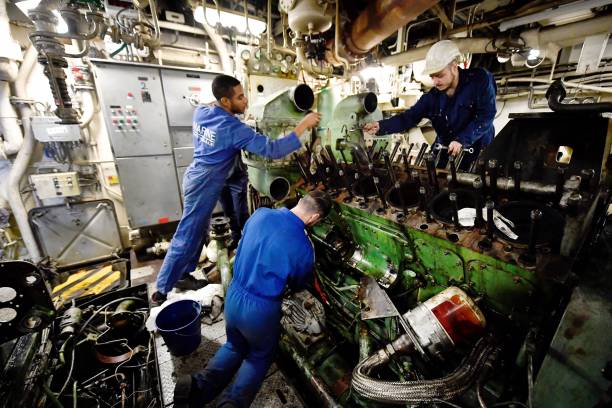 Crew working inside a ship's engine room