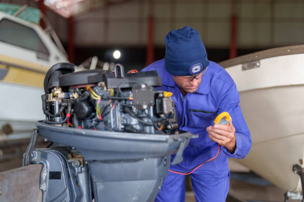 Technician servicing an outboard boat engine